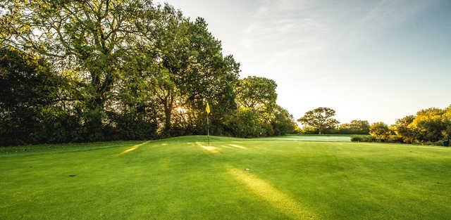 A sunny day view of a hole at Sturminster Marshall Golf Club.