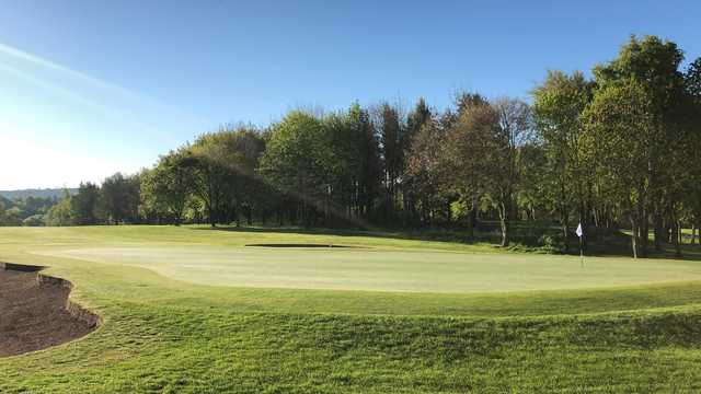A sunny day view of a green at Durham City Golf Club.
