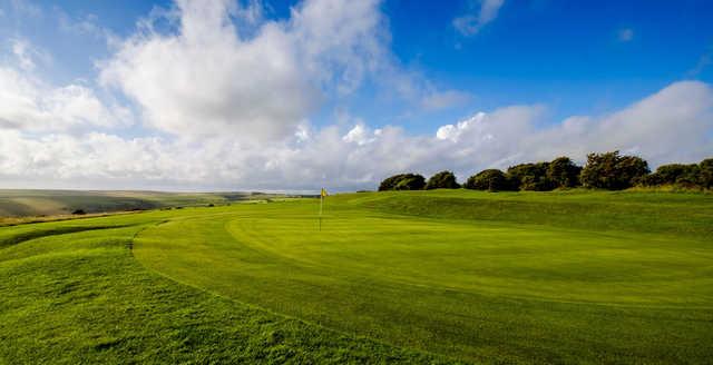 A sunny day view of a hole at Brighton & Hove Golf Club.