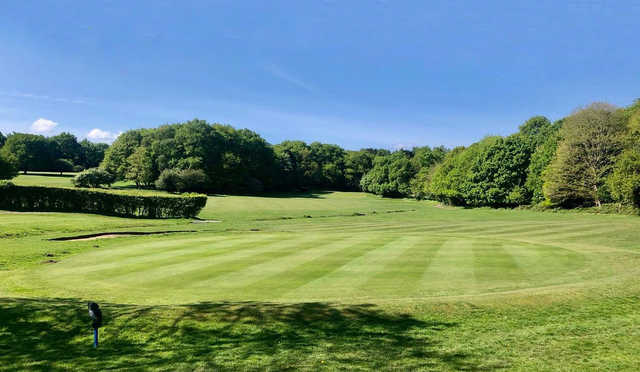 A sunny day view of a green at Theydon Bois Golf Club.