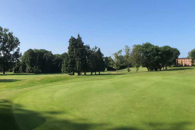 A sunny day view from green #12 at Coombe Wood Golf Club.