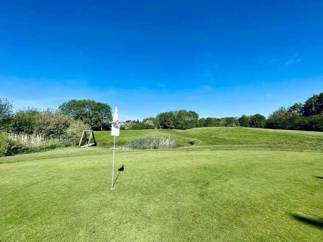 A sunny day view of a hole at Metro Golf Centre.