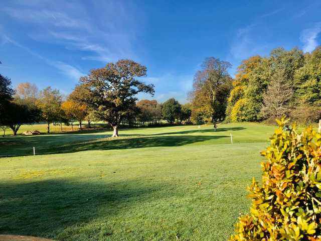 A splendid fall day view of a green at Chorlton-cum-Hardy Golf Club.