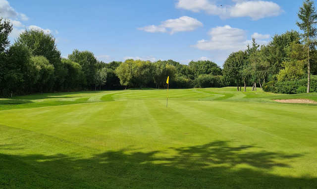 A sunny day view of a hole at Houldsworth Golf Club.