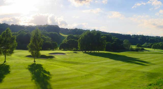 A sunny day view of a well protected hole at Reddish Vale Golf Club.