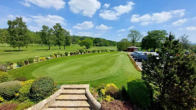 A sunny day view of the putting green at Romiley Golf Club.