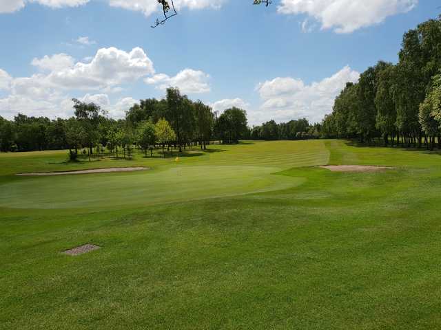 A sunny day view of a hole at Whitefield Golf Club.