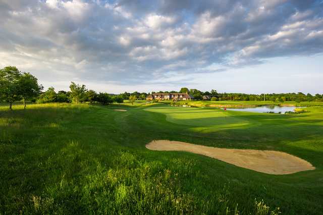 A view of a green and the clubhouse at Cams Hall Estate Golf Club.