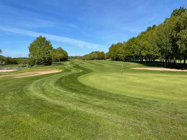 A sunny day view of a green at Sapey Golf Club.