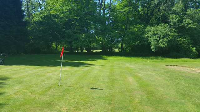 A sunny day view of a green at Roundwood Hall Golf Club.