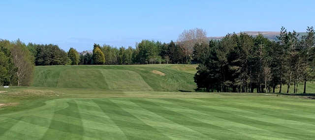A sunny day view from a fairway at Accrington & District Golf Club.