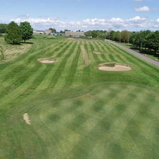 Aerial view of a fairway and green at Rathbane Golf Course.