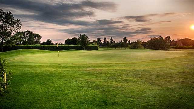 A sunset view of a hole at Waltham Windmill Golf Club.