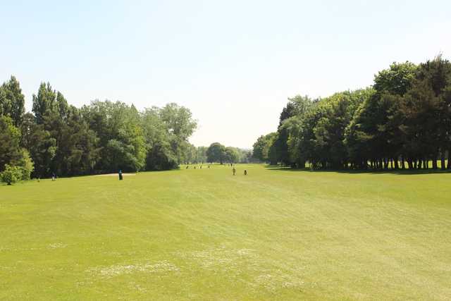 A sunny day view of a fairway at Brackenwood Golf Course.