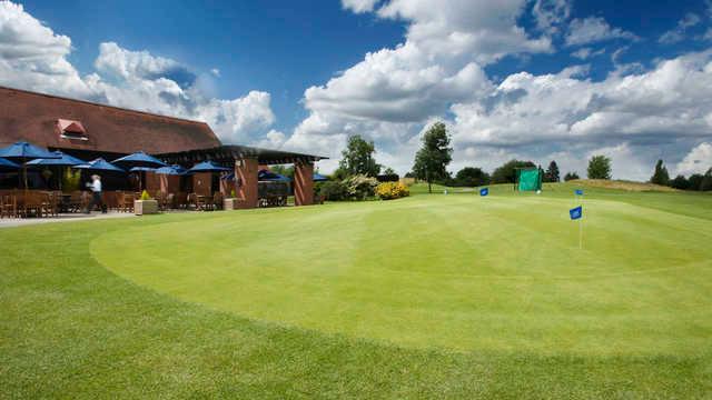 A view of the clubhouse and putting green from The Club At Mapledurham.