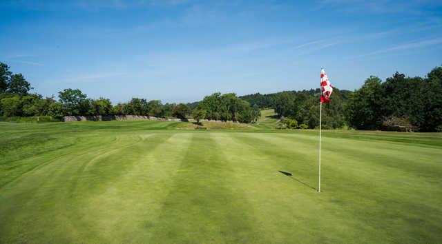 A sunny day view of green #16 at Bristol & Clifton Golf Club.