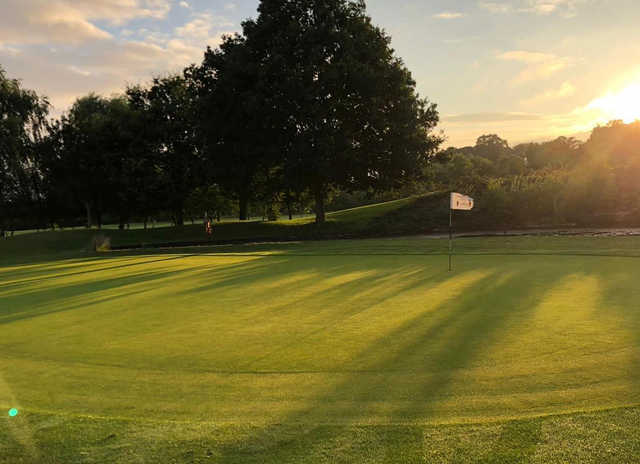 A sunset view of a green at Brett Vale Golf Club.