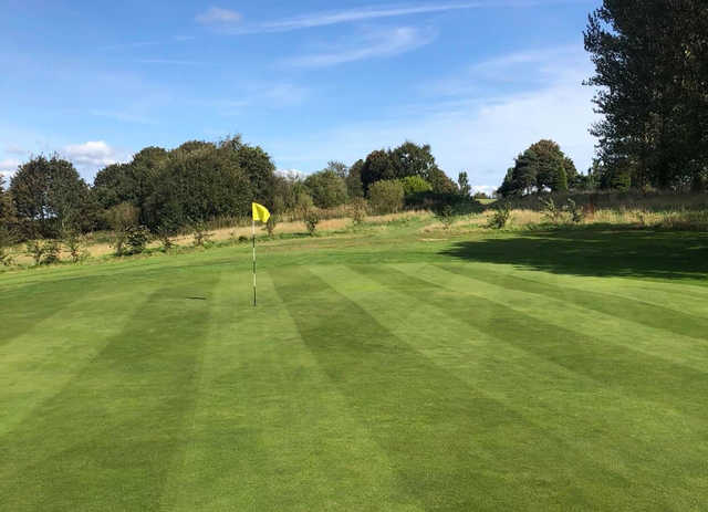 A sunny day view of a hole at Woodhall Hills Golf Club.