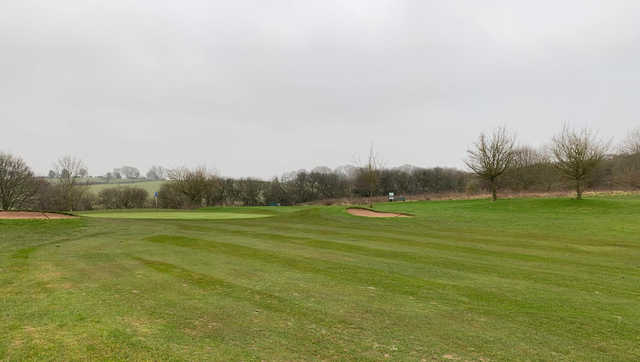 A view of a green flanked by bunkers at Little Lakes Golf Club.