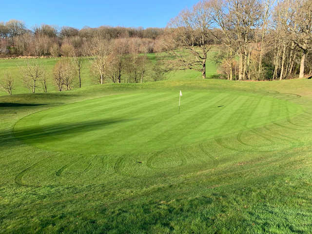 A sunny day view of a green at Little Lakes Golf Club.