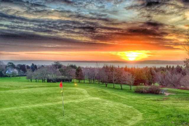 A sunset view of a green at Greenisland Golf Club.