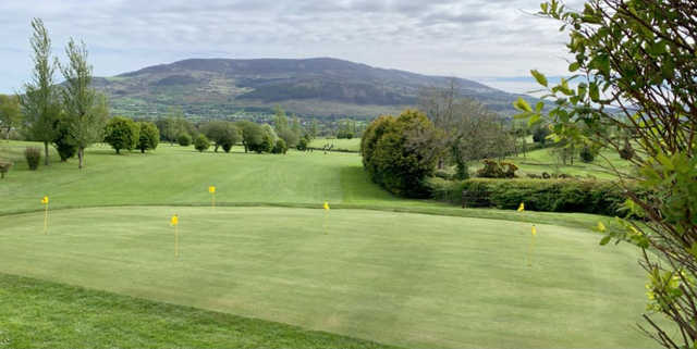 A view of the practice putting green and a fairway at Cloverhill Golf Club.