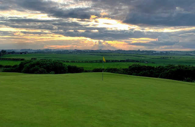 A sunset view of a hole at Kirkistown Castle Golf Club.