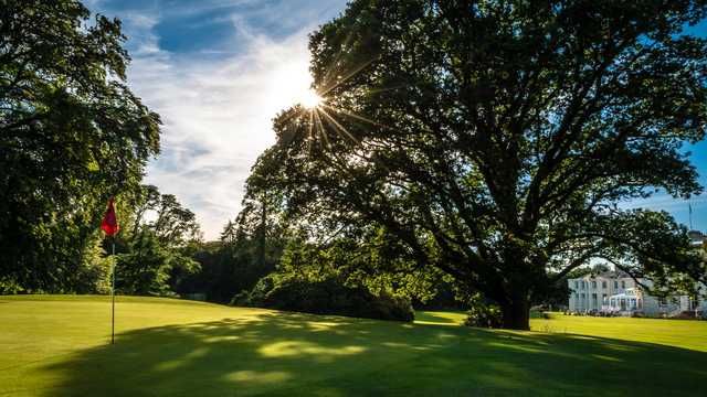 A sunny day view of a green at Cally Palace Hotel.