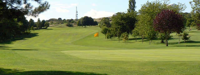 A sunny day view of a green at Craigmillar Park Golf Club.