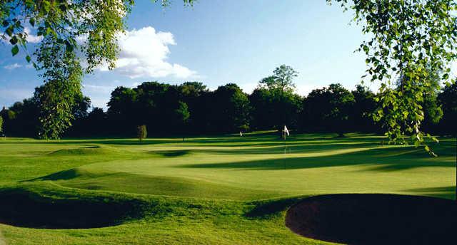 A sunny day view of two greens at Glenbervie Golf Club.
