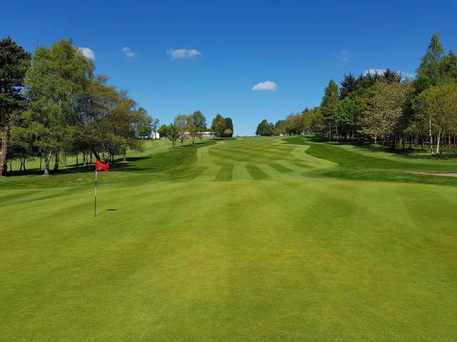 A sunny day view of a hole at Canmore Golf Club.