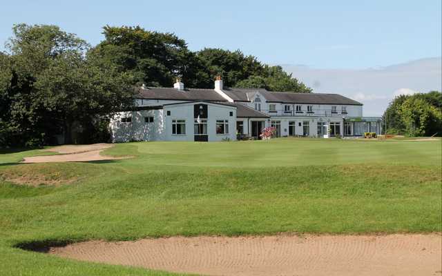 View of the clubhouse from the 18th green at Lees Hall Golf Club.
