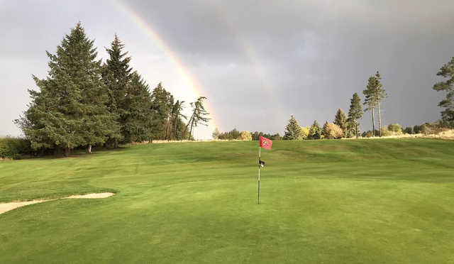 A view of a green protected by a double rainbow at Hamilton Golf Club.