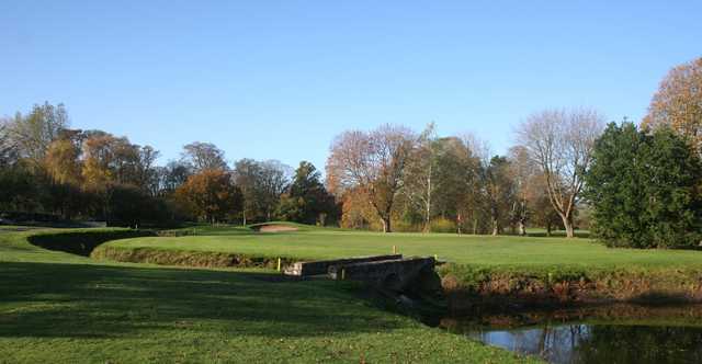 A view of a green surrounded by water at Northop Golf Club,