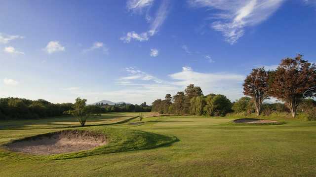 A view of a green protected by bunkers at Pwllheli Golf Club.