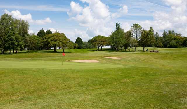 A sunny day view of a green at Fairwood Park Golf Club.