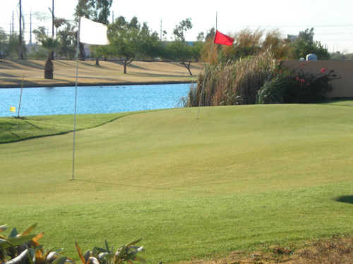 A view of the chipping green with water in background at Rio Salado Golf Course