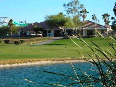A view over the water of the clubhouse and putting green at Rio Salado Golf Course