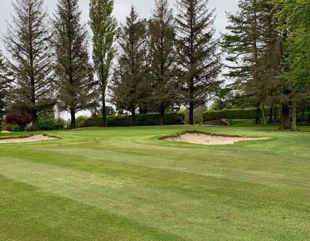 A view of a greenflanked by bunkers at Kanturk Golf Club.