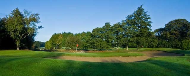 A view of two greens protected by bunkers at Highfield Golf Club.