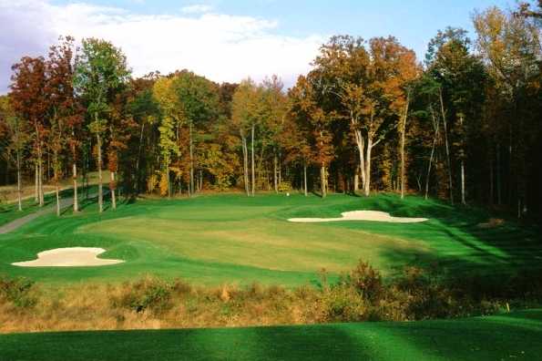 A fall view of green protected by bunkers at Augustine Golf Club