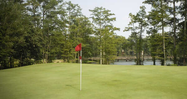 A view of green with water in background at Suffolk Golf Course