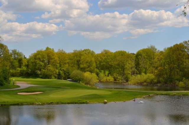 A view of a hole surrounded by water at Douglaston Golf Club