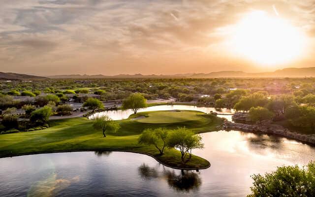 A sunset view of a green at Persimmon Course from Anthem Golf & Country Club.