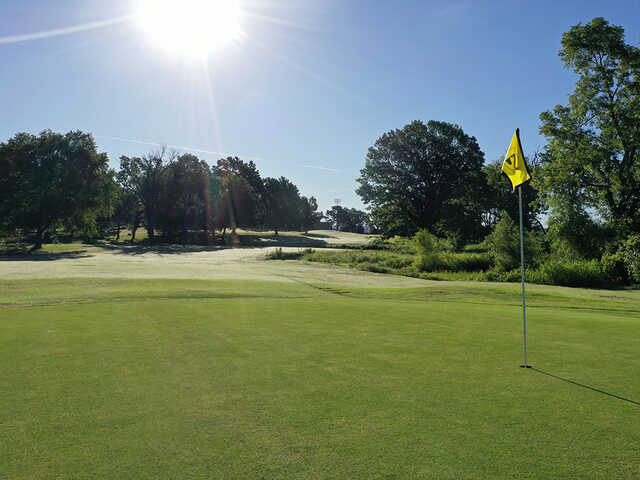 A sunny day view of a hole at Siloam Springs Country Club.