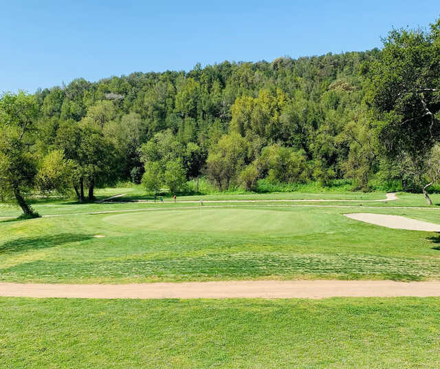 A sunny day view of a hole at Redwood Canyon Golf Course.