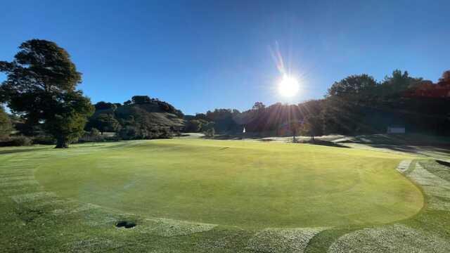 A sunny day view of a green at Indian Valley Golf Club.