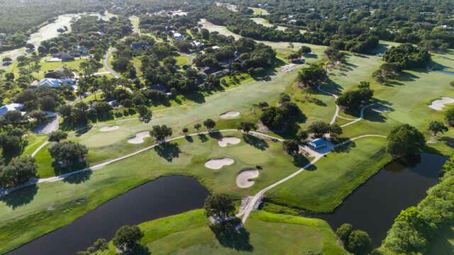 Aerial view of a green and fairway from Banyan Creek Golf Club