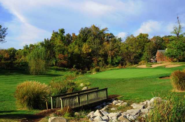 A view of a hole with bridge in foreground at Far Oaks Golf Club