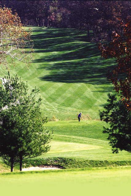 A fall view of a tee and a fairway at Scovill Golf Club